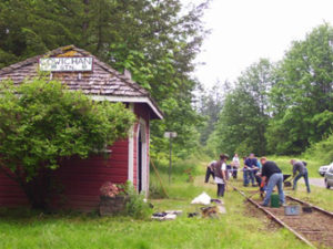 Cowichan Station volunteers clear weeds from their adopted mile of corridor.